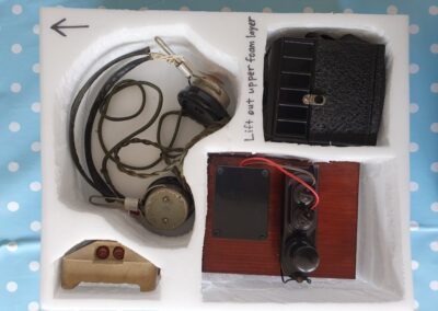 Communications (clockwise from left): Pair of headphones, box camera, working Morse code key, cat's eye road stud.