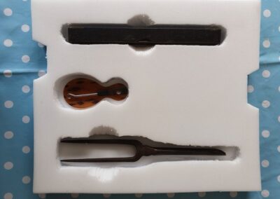 Everyday Inventions (top to bottom): Spirit level, shoe horn/button hook tool, curling tongs.